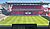 A panoramic view of a modern soccer stadium featuring a well-maintained pitch and empty seating areas.