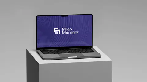Laptop displaying the "Milan Manager" logo on a purple background, positioned on a gray pedestal.