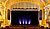 Ornate theater interior featuring a grand stage with purple curtains, decorative gold accents, and seating in front.
