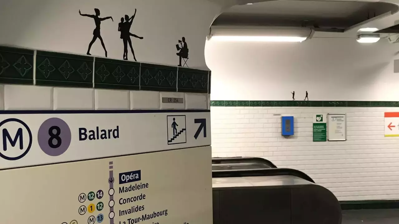 Metro station sign for Line 8, indicating direction to Balard, with silhouettes of dancers above the sign. Escalator visible in the background.