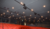 Interior of a theater featuring rows of red seats and overhead lighting fixtures.