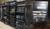 Multiple server racks filled with various electronic equipment and cables, showcasing a complex network setup.