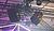 Suspended audio speakers and lighting fixtures are mounted on a metal truss in a venue, with colorful lighting effects visible.