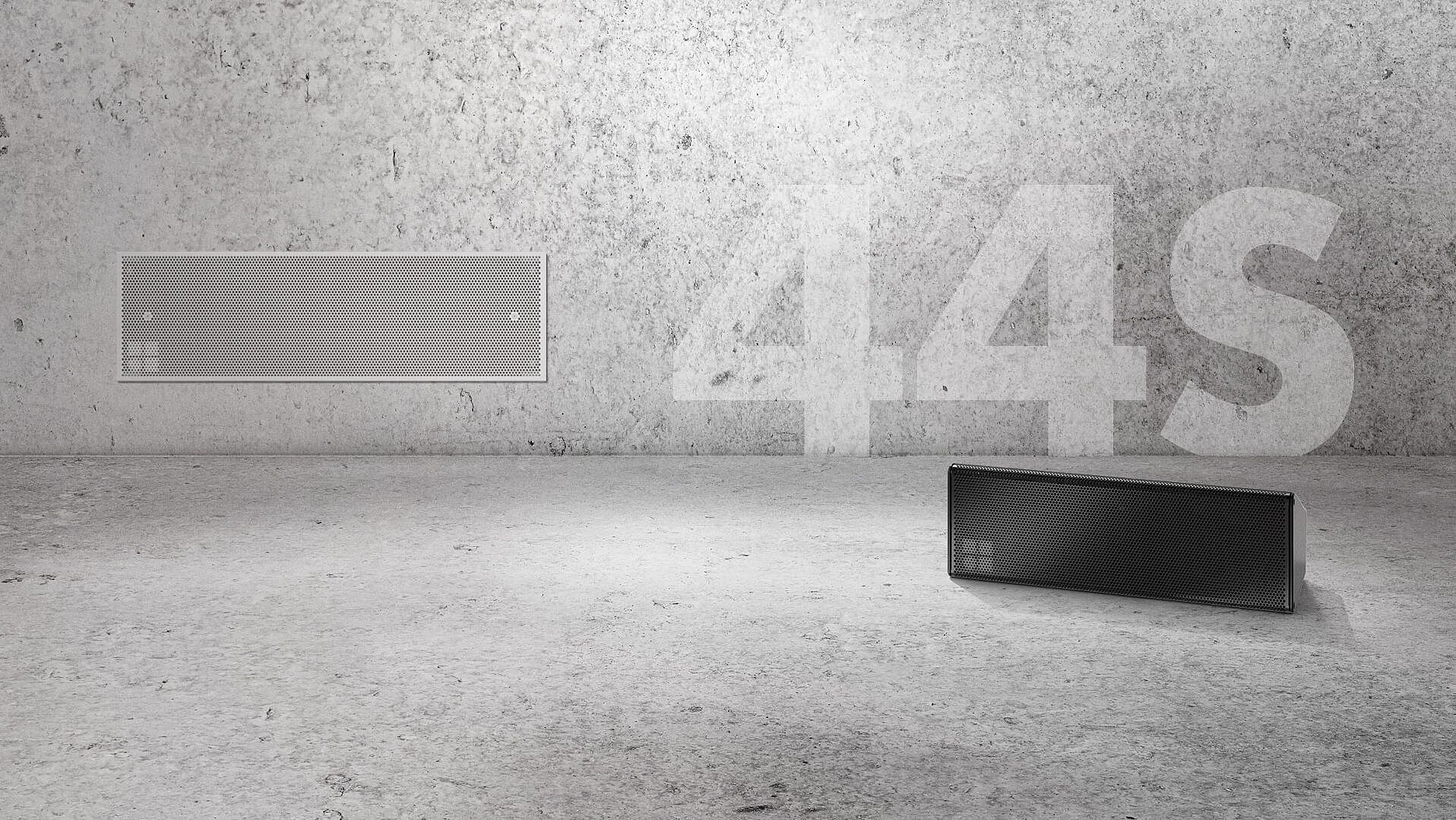 Two audio speakers are displayed against a textured gray wall, with the text "44S" prominently featured in the background.