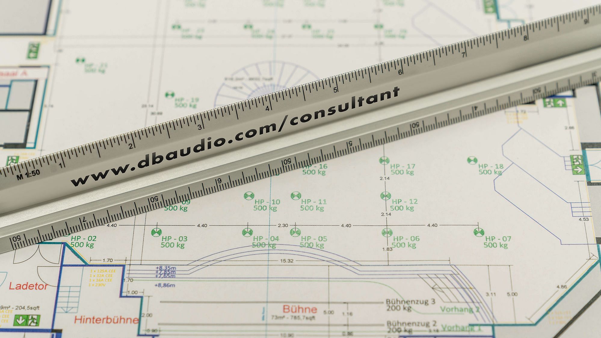 Architectural blueprint featuring detailed measurements and annotations, with a ruler placed across the plan.