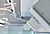 Ceiling-mounted air conditioning units are visible, suspended from white pipes in a modern interior space.