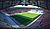 A panoramic view of a modern soccer stadium featuring a well-maintained pitch and empty seating areas.